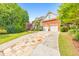 Spacious two-story home boasts a brick facade, well-kept lawn and long driveway leading to an attached garage at 1250 Rosette Way, Marietta, GA 30062