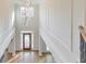 Spacious two-story foyer with hardwood floors, a chandelier, and paneled walls at 1250 Rosette Way, Marietta, GA 30062