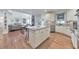 Open-concept kitchen with an island, stainless appliances, hardwood floors, and ample counter space at 1250 Rosette Way, Marietta, GA 30062