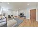 Cozy living room features hardwood floors, a comfortable couch, and a modern entertainment center with a large television at 1250 Rosette Way, Marietta, GA 30062
