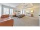 Spacious main bedroom with neutral colors, carpeted floors, tray ceilings, and large windows at 1250 Rosette Way, Marietta, GA 30062