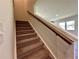 Carpeted staircase with wooden railing leading to the upper level of the home at 2685 Mourning Dove Drive Lot 53, Grayson, GA 30017