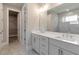 Bathroom with double vanity, modern fixtures, and tiled shower for a sleek and functional space at 329 Willow Cv, Canton, GA 30114