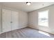 Bright bedroom features neutral carpet, natural light, and a convenient double-door closet at 329 Willow Cv, Canton, GA 30114
