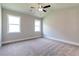 Relaxing bedroom with neutral walls, plush carpet, and natural light from two windows at 329 Willow Cv, Canton, GA 30114
