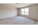 Comfortable bedroom with neutral walls, plush carpeting, and a window overlooking the outdoors at 329 Willow Cv, Canton, GA 30114