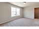 This bedroom offers natural light from a large window and closet space for ample storage at 329 Willow Cv, Canton, GA 30114
