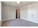 Spacious bedroom featuring plush carpeting and a double-door closet for ample storage at 329 Willow Cv, Canton, GA 30114