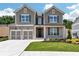 Charming two-story home featuring a two-car garage and beautifully landscaped front yard at 329 Willow Cv, Canton, GA 30114