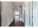 Inviting hallway featuring hardwood floors and views into other rooms of the house at 329 Willow Cv, Canton, GA 30114