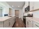 Modern kitchen with white cabinets, stainless steel appliances, granite countertops, and hardwood flooring at 329 Willow Cv, Canton, GA 30114