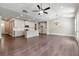 Spacious open-concept area with hardwood floors, white kitchen cabinets, modern lighting, and vaulted ceilings at 329 Willow Cv, Canton, GA 30114
