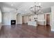 Open-concept living room flows into the kitchen, featuring hardwood floors, fireplace, and contemporary lighting at 329 Willow Cv, Canton, GA 30114