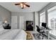 Neutral bedroom with ensuite, ceiling fan and large windows at 3986 Church View Ln, Suwanee, GA 30024