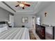 Open main bedroom with tray ceiling, ceiling fan and view into the bathroom at 3986 Church View Ln, Suwanee, GA 30024