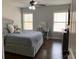 This bedroom is nicely lit, with ample windows, a desk, and storage space at 4241 Summer Breeze Way, Buford, GA 30518