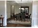 Open dining area with modern chandelier, wainscotting, and seating for six at 4241 Summer Breeze Way, Buford, GA 30518