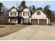 Charming two-story home with brick facade, manicured lawn, and attached two-car garage at 4241 Summer Breeze Way, Buford, GA 30518
