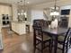 This kitchen is complete with white cabinets, a granite island, and stainless steel appliances at 4241 Summer Breeze Way, Buford, GA 30518