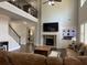 Open-concept living room with vaulted ceiling, fireplace, and built-in shelving at 4241 Summer Breeze Way, Buford, GA 30518