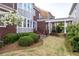 Beautifully landscaped backyard featuring a covered walkway and attractive greenery at 8095 Georgetown Cir, Suwanee, GA 30024