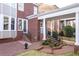 Backyard with brick patio, covered walkway, and lush landscaping creates a relaxing outdoor space at 8095 Georgetown Cir, Suwanee, GA 30024