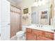Neutral bathroom with a vanity, framed mirror, and shower-tub combo with shower curtain at 8095 Georgetown Cir, Suwanee, GA 30024