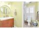 Bathroom featuring natural light, neutral walls, and single sink vanity at 8095 Georgetown Cir, Suwanee, GA 30024