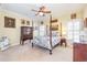 Comfortable bedroom with a four-poster bed, classic decor, and neutral tones, creating a serene retreat at 8095 Georgetown Cir, Suwanee, GA 30024