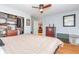Bedroom with hardwood floors, large closet, natural light, and ceiling fan at 8095 Georgetown Cir, Suwanee, GA 30024