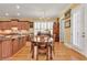 A charming dining area boasts hardwood floors, a chandelier, and ample natural light from plantation shutters at 8095 Georgetown Cir, Suwanee, GA 30024