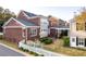 Rear exterior view of townhome showing the brick facade and walkway at 8095 Georgetown Cir, Suwanee, GA 30024
