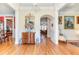 Elegant foyer with hardwood floors, arched doorways, and classic furnishings showcased with refined decor at 8095 Georgetown Cir, Suwanee, GA 30024