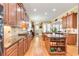 Spacious kitchen with custom wood cabinets, granite countertops, stainless steel appliances, and hardwood floors at 8095 Georgetown Cir, Suwanee, GA 30024