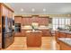 Modern kitchen featuring hardwood floors, stainless steel appliances, granite countertops, and custom wood cabinets at 8095 Georgetown Cir, Suwanee, GA 30024