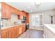 Kitchen features granite countertops, stainless appliances, wood cabinets, and natural light at 8095 Georgetown Cir, Suwanee, GA 30024
