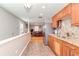 Kitchen with stainless steel appliances, granite countertops, wood cabinets, and natural light at 8095 Georgetown Cir, Suwanee, GA 30024