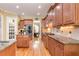 Well-appointed kitchen with hardwood floors, stainless steel appliances, and custom cabinetry offering ample storage at 8095 Georgetown Cir, Suwanee, GA 30024