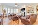 Bright and airy living room with fireplace, built-ins, and plantation shutters offering plenty of light at 8095 Georgetown Cir, Suwanee, GA 30024