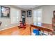 Living room with hardwood floors, natural light, and entertainment/exercise area at 8095 Georgetown Cir, Suwanee, GA 30024