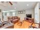 Cozy living room with hardwood floors, comfortable seating, and natural light at 8095 Georgetown Cir, Suwanee, GA 30024