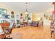 Cozy living room featuring hardwood floors, a leather sofa, decorative wall art, and classic furnishings at 8095 Georgetown Cir, Suwanee, GA 30024