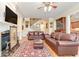 Elegant living room featuring hardwood floors, a fireplace, and a staircase at 8095 Georgetown Cir, Suwanee, GA 30024