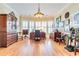 Traditional office featuring hardwood floors, a chandelier, window shutters, and rich wood furnishings at 8095 Georgetown Cir, Suwanee, GA 30024