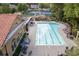 Community pool with lounge chairs, umbrellas, and a playground, perfect for relaxation at 8095 Georgetown Cir, Suwanee, GA 30024