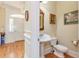 Well-appointed powder room with pedestal sink and decorative mirror at 8095 Georgetown Cir, Suwanee, GA 30024