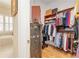 Well-organized walk-in closet with custom shelving and a unique antique safe door at 8095 Georgetown Cir, Suwanee, GA 30024
