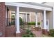 An inviting covered walkway with classic columns connects the townhome units at 8095 Georgetown Cir, Suwanee, GA 30024