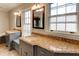 Bathroom featuring double sinks, granite countertops, and natural light from large windows at 2141 Conyers Se St, Covington, GA 30014