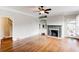 Inviting living room with hardwood floors, a decorative fireplace, and built-in shelving at 2141 Conyers Se St, Covington, GA 30014